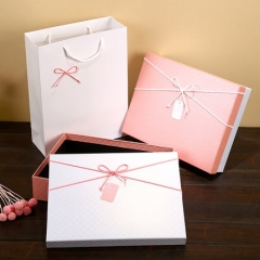 Cardboard box with bow and packaging bag